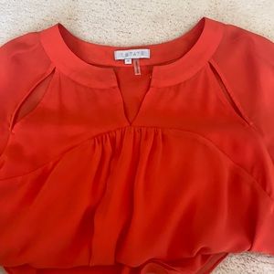 1. state bright orange blouse